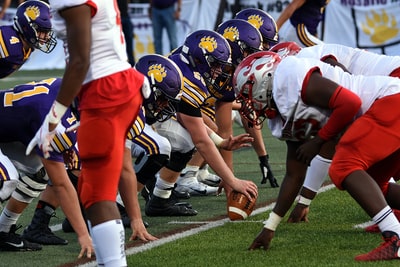 Football players wearing red and white shirt
